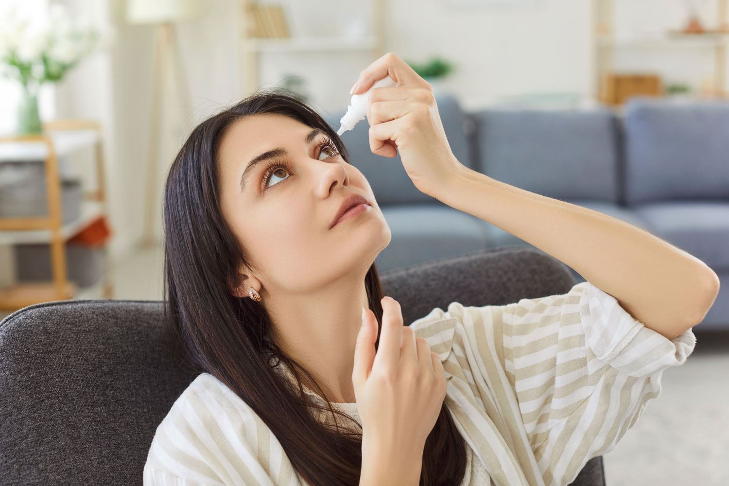 Woman using eye drops for dry eye